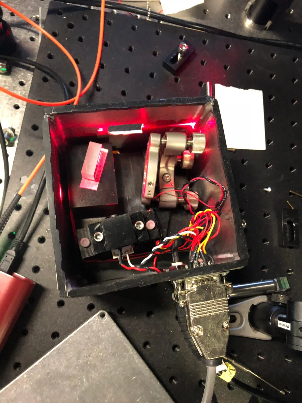 Inside a home-built external-cavity diode laser: the diode, collimating optics, and a diffraction grating on a kinematic mount for frequency tuning.
