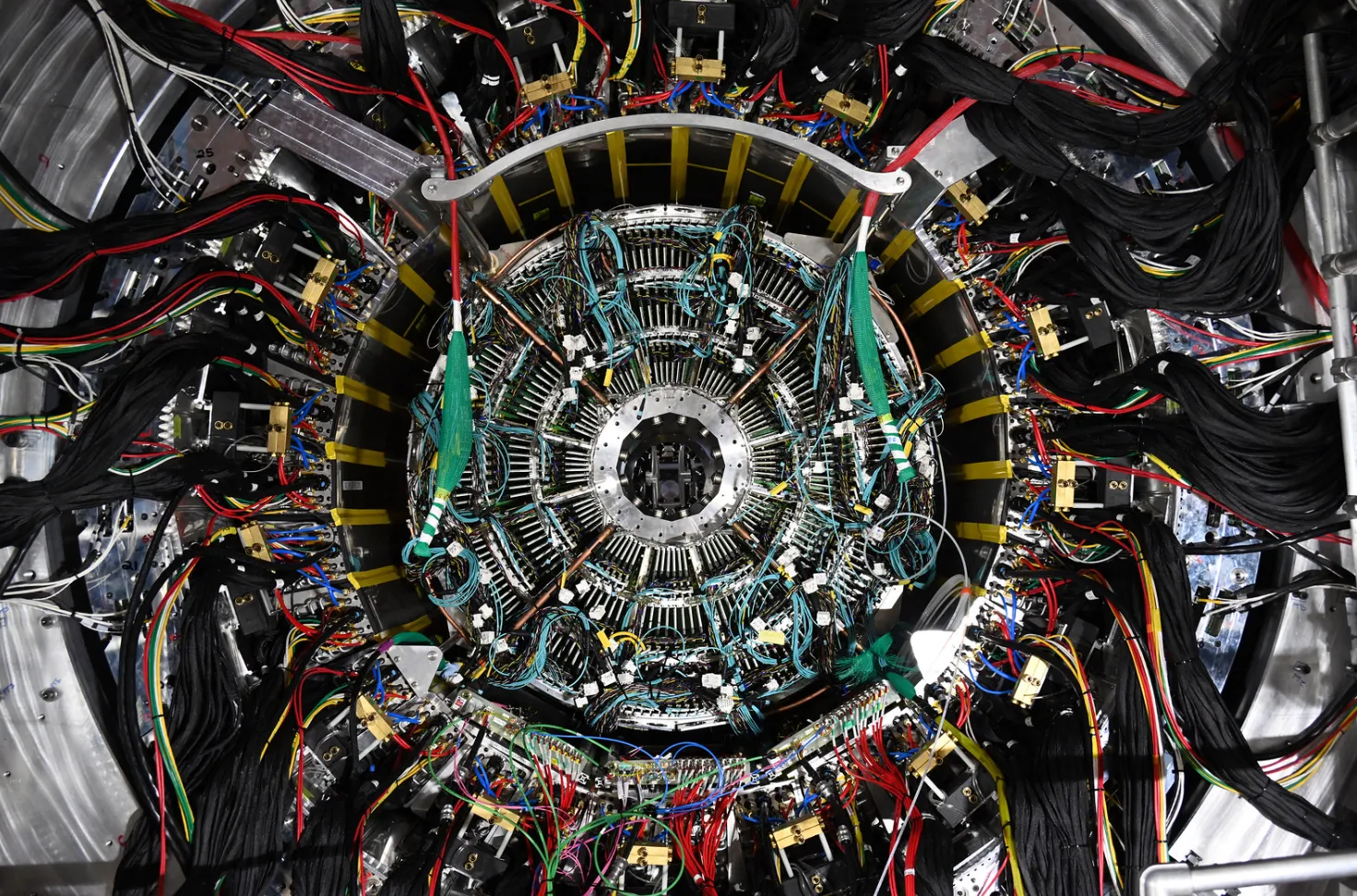 Looking straight down the bore of the sPHENIX detector at RHIC — the tracking layers, calorimeters, and readout cabling of the experiment I did detector R&D for.
